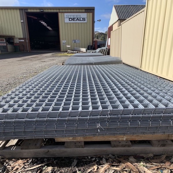 Sheets of reinforcing mesh stacked on pallets in the yard