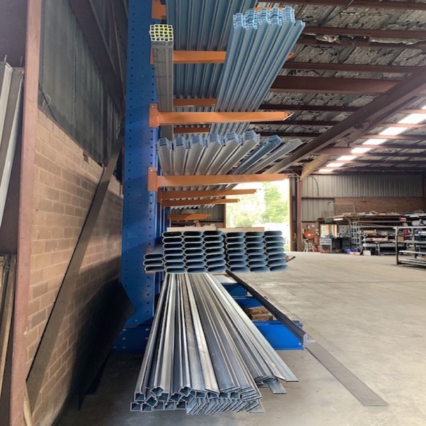 Steel lengths on cantilever racking beside an open roller door