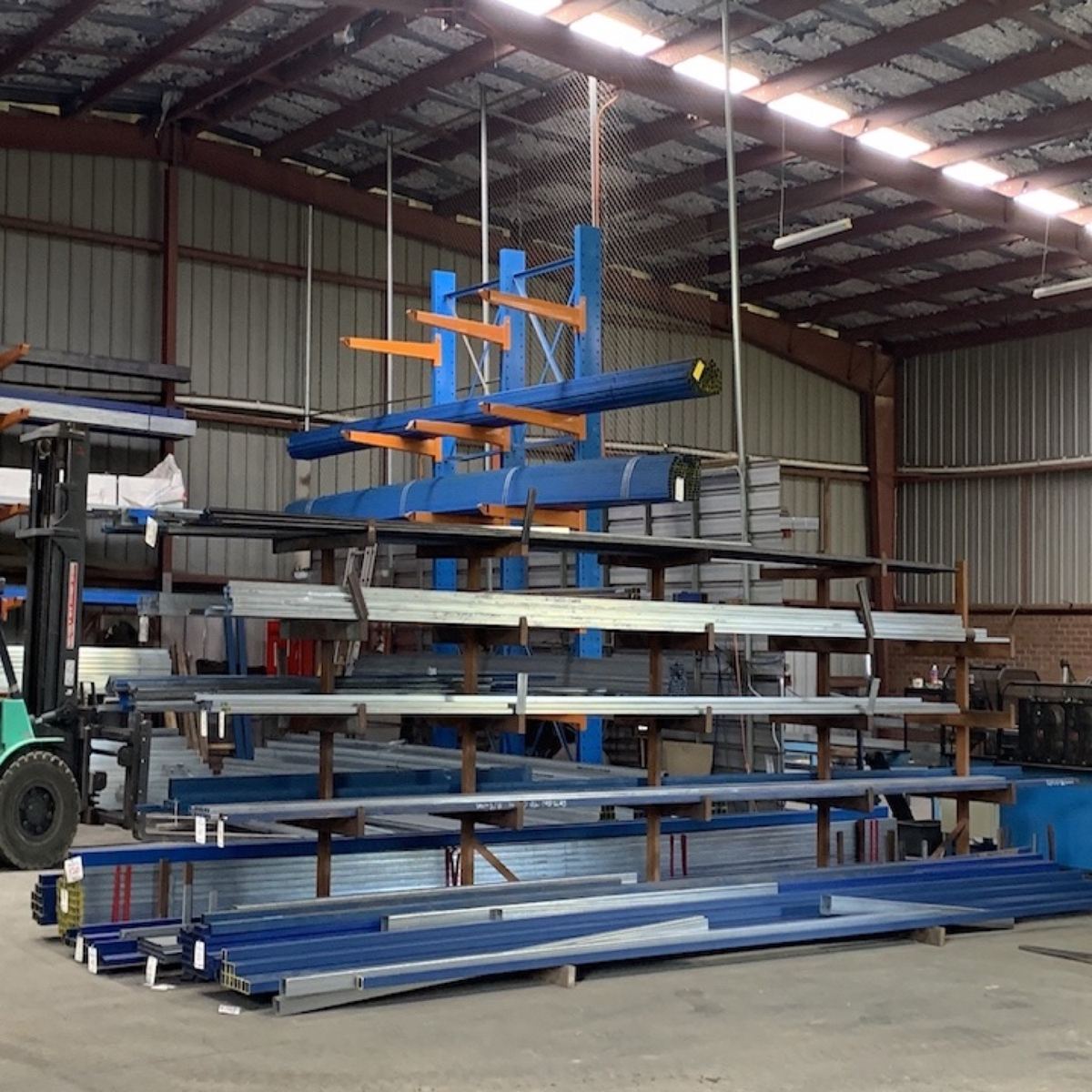 A forklift beside loaded steel racking inside the Steel Deals Bendigo warehouse