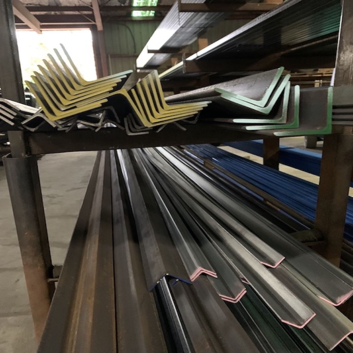 Angle and flat bar stacked on a rack in the warehouse