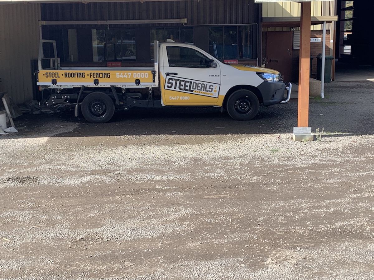 The Steel Deals Bendigo ute parked in the yard, signwritten steel, roofing and fencing