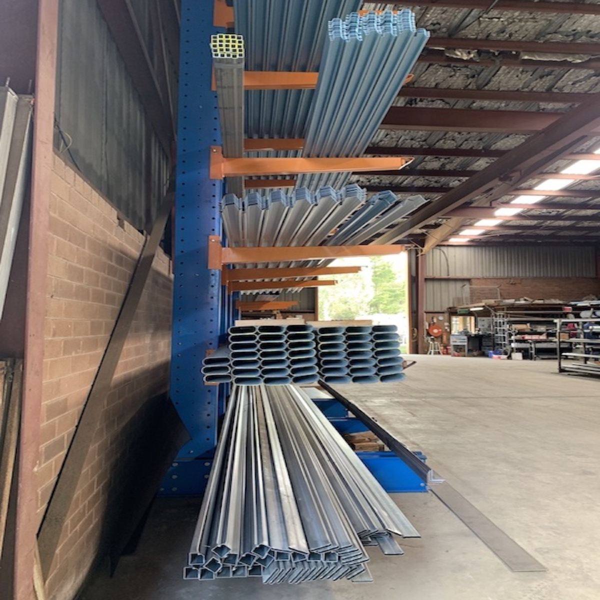 Steel lengths on cantilever racking beside an open roller door