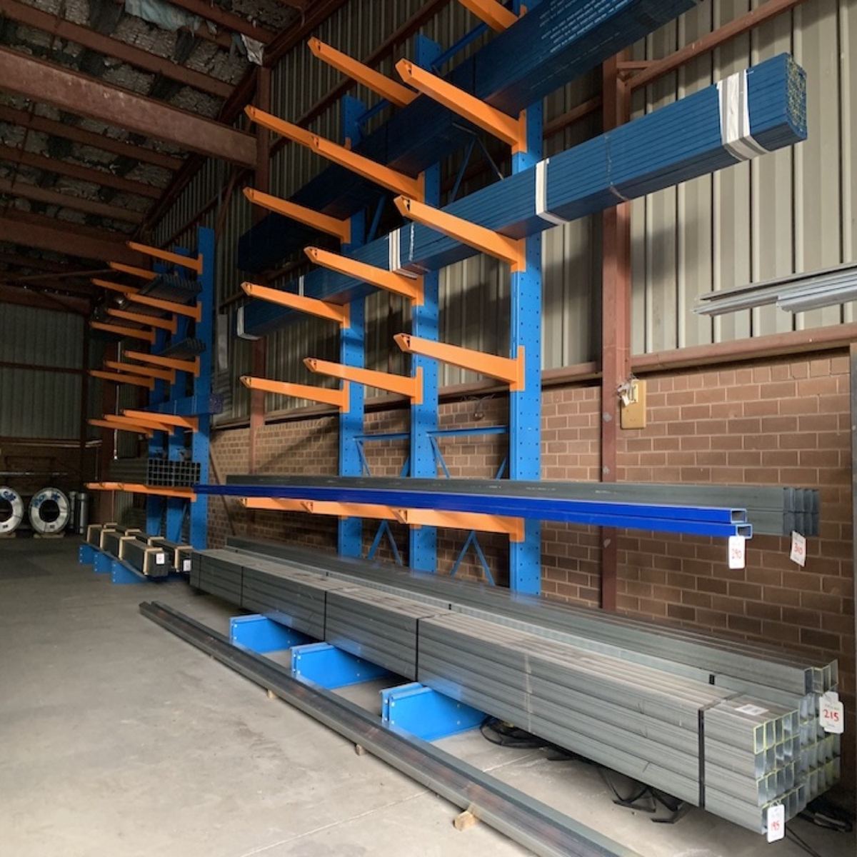 Bundles of steel banded with blue strapping on a rack